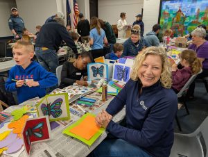 Kathy Little helping children make butterfly cards | Kiwanis Craft Days | Kiwanis Club of Bradford