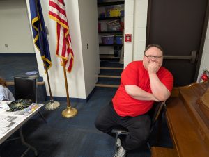 Chris Lathrop lounging by the piano after helping children make record mandalas | Kiwanis Kraft Days | Kiwanis Club of Bradford